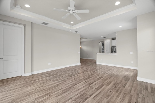 11354 Callisia Dr, Odessa, FL 33556 - unfurnished living room featuring a tray ceiling, a ceiling fan, light wood-type flooring, recessed lighting, and baseboards