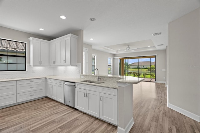 11354 Callisia Dr, Odessa, FL 33556 - kitchen with stainless steel dishwasher, a sink, light wood-type flooring, a peninsula, and recessed lighting