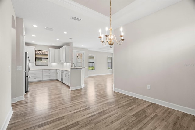 11354 Callisia Dr, Odessa, FL 33556 - kitchen with open floor plan, appliances with stainless steel finishes, light wood-style flooring, baseboards, and a peninsula