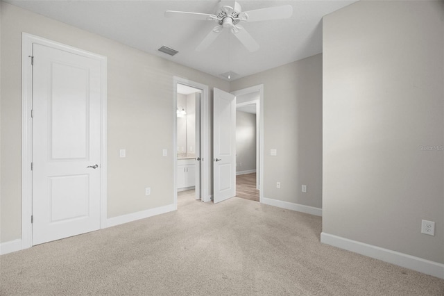 11354 Callisia Dr, Odessa, FL 33556 - unfurnished bedroom featuring light colored carpet, baseboards, ensuite bath, and a ceiling fan