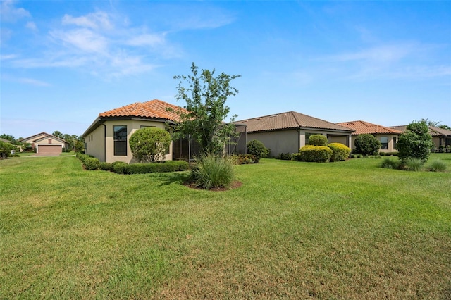 11354 Callisia Dr, Odessa, FL 33556 - back of house featuring a tile roof, stucco siding, a lawn, and an attached garage