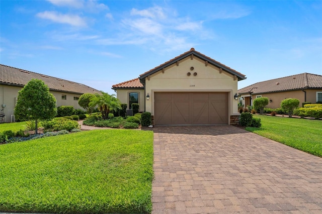 11354 Callisia Dr, Odessa, FL 33556 - mediterranean / spanish-style house with decorative driveway, a front yard, stucco siding, an attached garage, and a tile roof