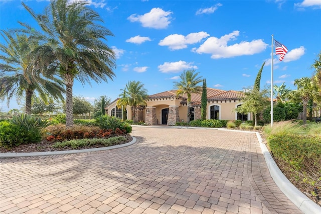 11354 Callisia Dr, Odessa, FL 33556 - mediterranean / spanish-style house featuring stucco siding, a tile roof, and stone siding