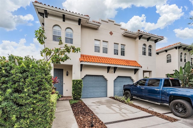 102 S Moody Ave Unit 1, Tampa, FL 33609 - view of front facade featuring a garage, stucco siding, concrete driveway, and a tiled roof