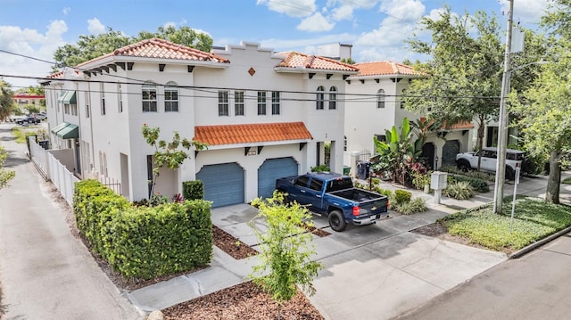 102 S Moody Ave Unit 1, Tampa, FL 33609 - mediterranean / spanish-style home featuring a tile roof, stucco siding, driveway, and an attached garage
