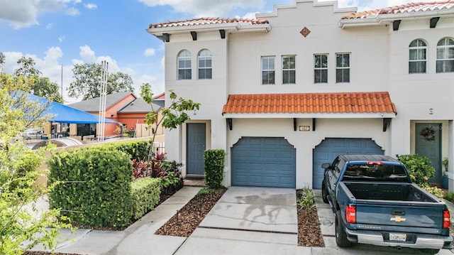 102 S Moody Ave Unit 1, Tampa, FL 33609 - mediterranean / spanish-style house with a tiled roof, concrete driveway, a garage, and stucco siding