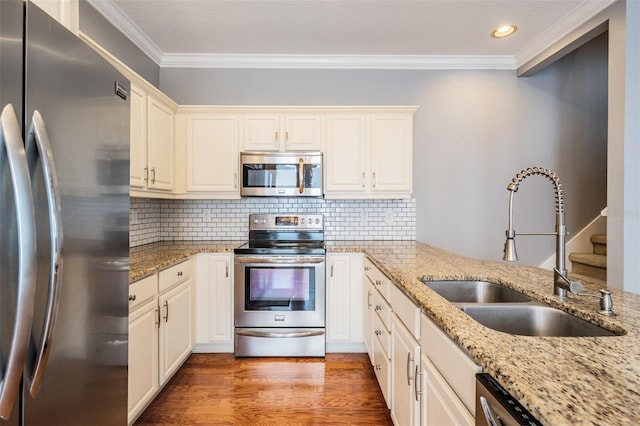 102 S Moody Ave Unit 1, Tampa, FL 33609 - kitchen with appliances with stainless steel finishes, a sink, ornamental molding, recessed lighting, and light wood-style floors