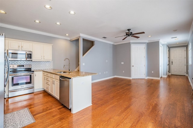 102 S Moody Ave Unit 1, Tampa, FL 33609 - kitchen with appliances with stainless steel finishes, a sink, a peninsula, a ceiling fan, and recessed lighting