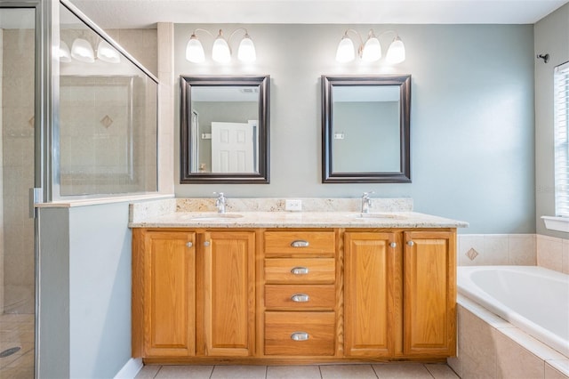 102 S Moody Ave Unit 1, Tampa, FL 33609 - bathroom featuring double vanity, a garden tub, a shower stall, and tile patterned floors