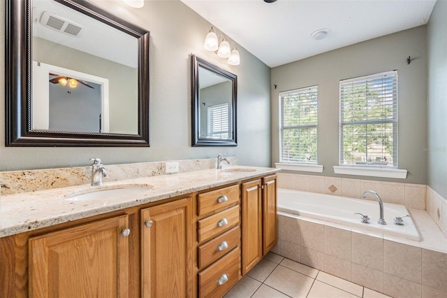 102 S Moody Ave Unit 1, Tampa, FL 33609 - bathroom with double vanity, a bath, and tile patterned floors