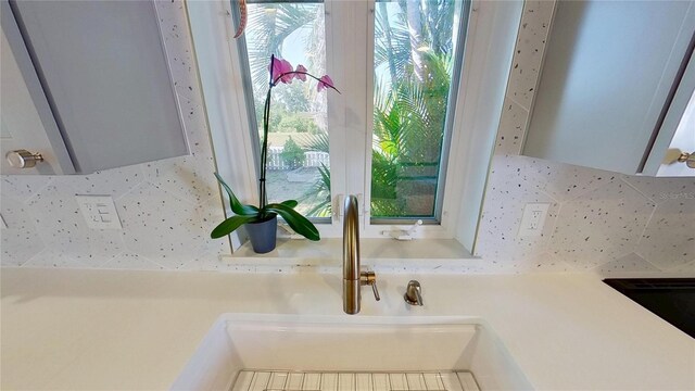 1200 47th St N, Saint Petersburg, FL 33713 - kitchen view of backsplash, a sink, and light countertops
