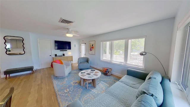 1200 47th St N, Saint Petersburg, FL 33713 - living area featuring light wood finished floors, a ceiling fan, and baseboards