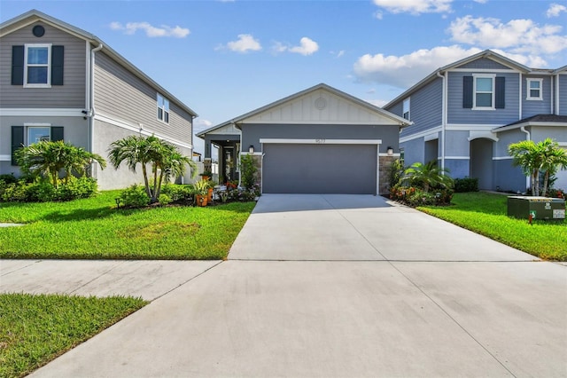 9577 Sandy Bluffs Cir, Parrish, FL 34219 - view of front of house with a front yard, concrete driveway, an attached garage, and board and batten siding