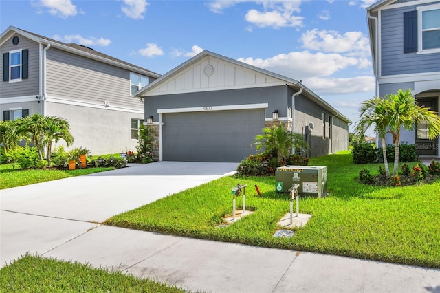 9577 Sandy Bluffs Cir, Parrish, FL 34219 - view of front of home with an attached garage, concrete driveway, a front yard, board and batten siding, and stone siding