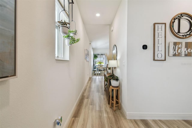 9577 Sandy Bluffs Cir, Parrish, FL 34219 - hall with light wood-type flooring, baseboards, and recessed lighting
