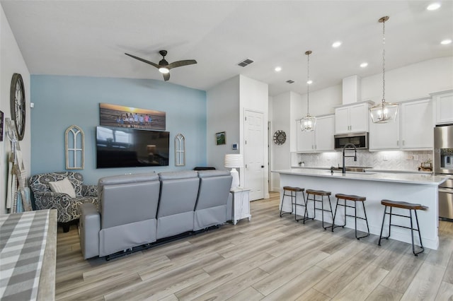 9577 Sandy Bluffs Cir, Parrish, FL 34219 - living area with light wood-style floors, a ceiling fan, recessed lighting, and vaulted ceiling