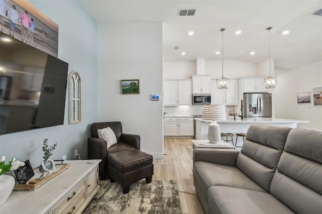 9577 Sandy Bluffs Cir, Parrish, FL 34219 - living room with light wood-style flooring, recessed lighting, and lofted ceiling