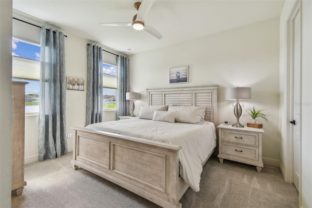 9577 Sandy Bluffs Cir, Parrish, FL 34219 - bedroom with light carpet, a ceiling fan, and baseboards