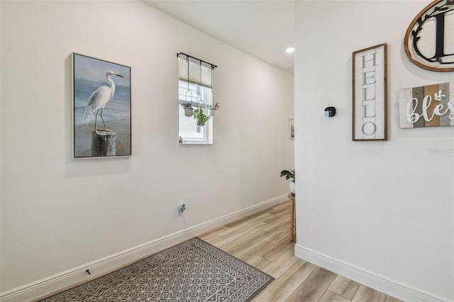 9577 Sandy Bluffs Cir, Parrish, FL 34219 - hallway with baseboards, light wood-style flooring, and recessed lighting
