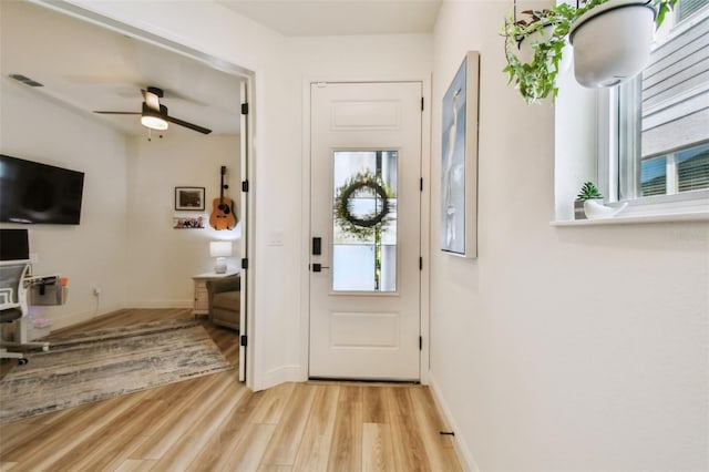 9577 Sandy Bluffs Cir, Parrish, FL 34219 - entryway with light wood-type flooring, ceiling fan, and baseboards