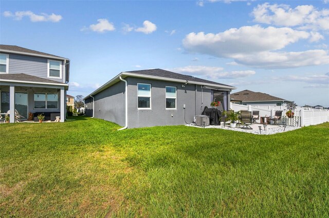 9577 Sandy Bluffs Cir, Parrish, FL 34219 - back of house with a patio area, stucco siding, and cooling unit