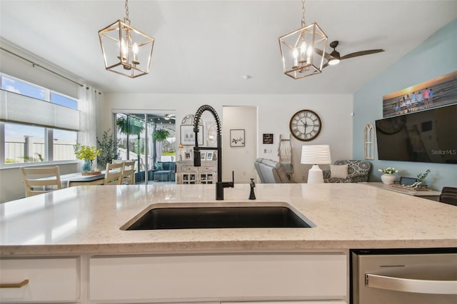 9577 Sandy Bluffs Cir, Parrish, FL 34219 - kitchen featuring a chandelier, open floor plan, a sink, decorative light fixtures, and vaulted ceiling