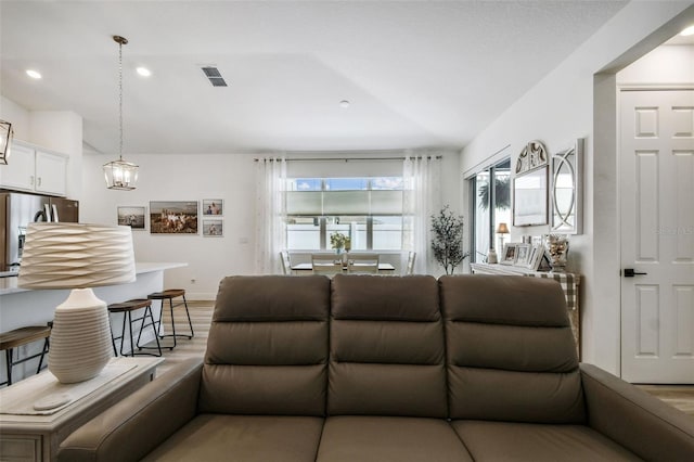 9577 Sandy Bluffs Cir, Parrish, FL 34219 - living room with light wood-type flooring, baseboards, and recessed lighting
