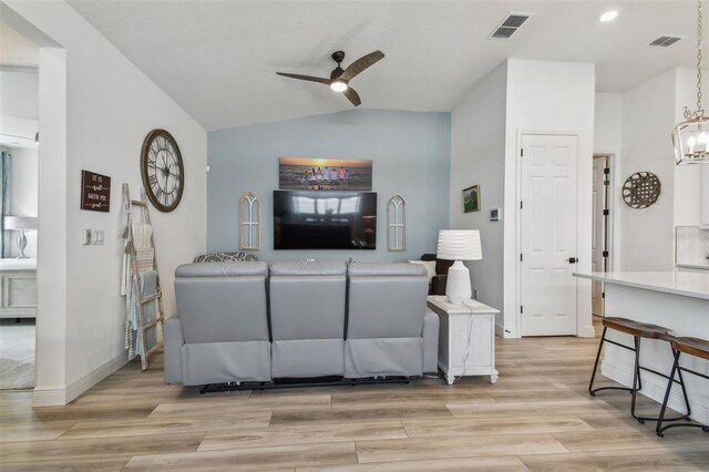9577 Sandy Bluffs Cir, Parrish, FL 34219 - living area featuring a ceiling fan, lofted ceiling, light wood finished floors, a chandelier, and baseboards