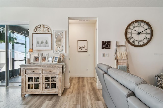 9577 Sandy Bluffs Cir, Parrish, FL 34219 - living room with light wood-style floors and baseboards