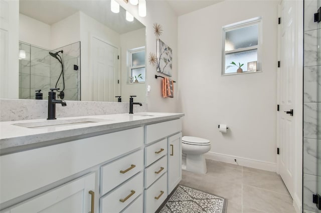 9577 Sandy Bluffs Cir, Parrish, FL 34219 - full bathroom featuring double vanity, toilet, a marble finish shower, baseboards, and tile patterned floors