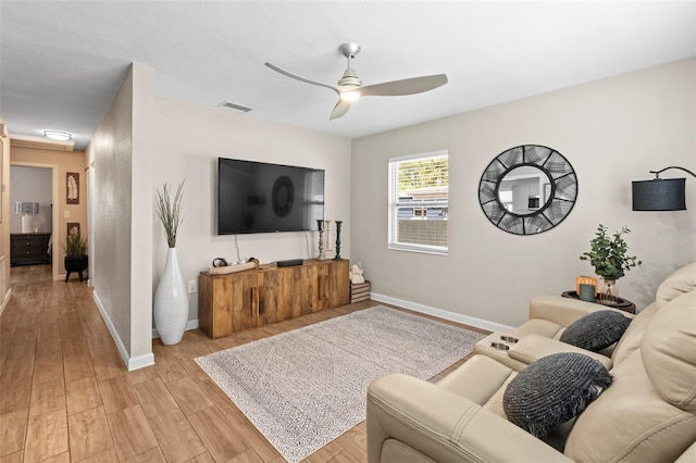512 Flame Tree Dr, Apollo Beach, FL 33572 - living area featuring a ceiling fan, baseboards, and light wood-style flooring