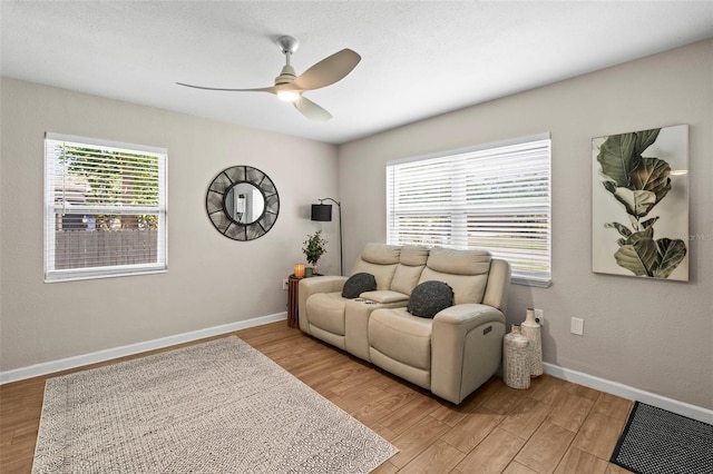 512 Flame Tree Dr, Apollo Beach, FL 33572 - living area featuring a ceiling fan, light wood finished floors, and baseboards