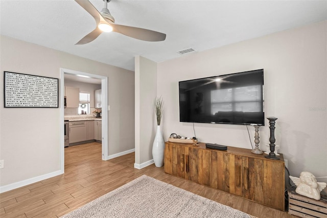 512 Flame Tree Dr, Apollo Beach, FL 33572 - living area with light wood-type flooring, a ceiling fan, and baseboards