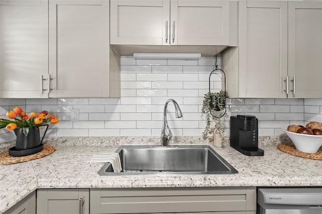 512 Flame Tree Dr, Apollo Beach, FL 33572 - kitchen featuring a sink, dishwasher, and tasteful backsplash