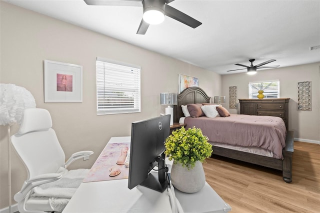 512 Flame Tree Dr, Apollo Beach, FL 33572 - bedroom with light wood-style floors, an office area, a ceiling fan, and baseboards