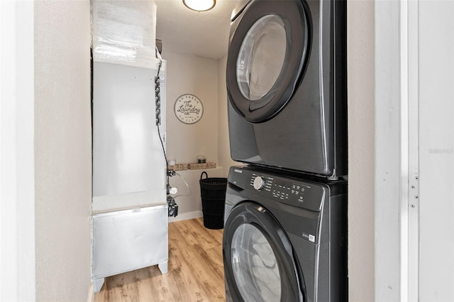 512 Flame Tree Dr, Apollo Beach, FL 33572 - washroom with stacked washer / drying machine and wood finished floors