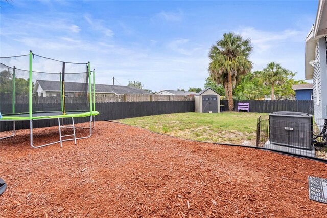 512 Flame Tree Dr, Apollo Beach, FL 33572 - view of yard featuring a trampoline and central AC unit
