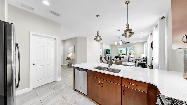 6118 Voyagers Pl, Apollo Beach, FL 33572 - kitchen featuring dishwasher, fridge, open floor plan, light countertops, and light tile patterned flooring