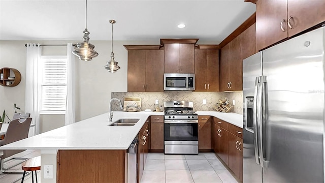 6118 Voyagers Pl, Apollo Beach, FL 33572 - kitchen featuring stainless steel appliances, a peninsula, light countertops, tasteful backsplash, and recessed lighting