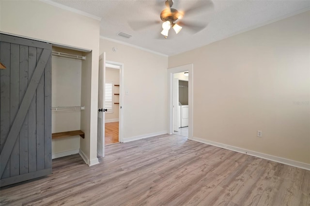 6419 S Englewood Ave, Tampa, FL 33611 - unfurnished bedroom featuring wood finished floors, a closet, washer / clothes dryer, crown molding, and baseboards