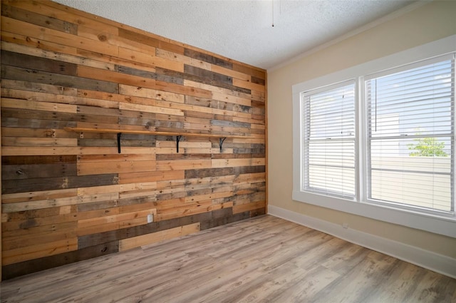 6419 S Englewood Ave, Tampa, FL 33611 - unfurnished room with wooden walls, wood finished floors, a textured ceiling, baseboards, and ornamental molding