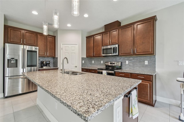 13311 Dorado Shores Ave, Riverview, FL 33579 - kitchen featuring stainless steel appliances, a sink, decorative backsplash, light stone countertops, and baseboards