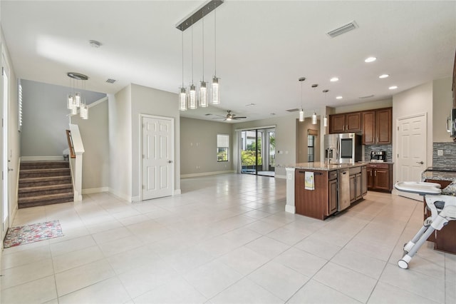 13311 Dorado Shores Ave, Riverview, FL 33579 - kitchen with open floor plan, backsplash, stainless steel fridge with ice dispenser, baseboards, and recessed lighting