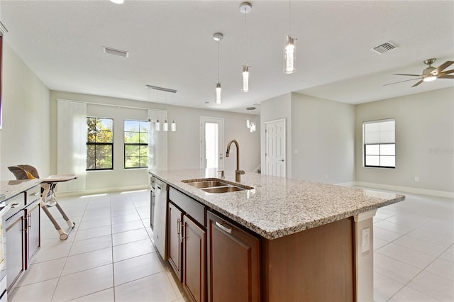13311 Dorado Shores Ave, Riverview, FL 33579 - kitchen with open floor plan, a sink, dishwasher, light tile patterned floors, and plenty of natural light