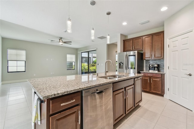 13311 Dorado Shores Ave, Riverview, FL 33579 - kitchen with appliances with stainless steel finishes, a sink, light tile patterned floors, a kitchen island with sink, and ceiling fan