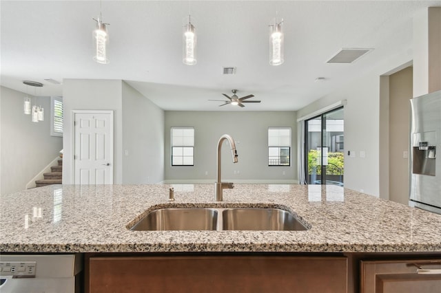 13311 Dorado Shores Ave, Riverview, FL 33579 - kitchen with a sink, open floor plan, ceiling fan, light stone countertops, and decorative light fixtures