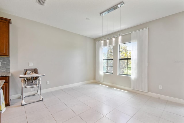 13311 Dorado Shores Ave, Riverview, FL 33579 - unfurnished dining area featuring light tile patterned floors and baseboards