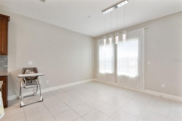 13311 Dorado Shores Ave, Riverview, FL 33579 - unfurnished dining area with baseboards and light tile patterned floors