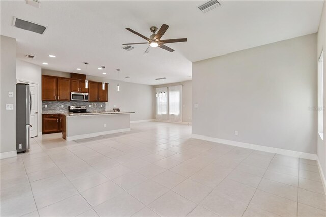 13311 Dorado Shores Ave, Riverview, FL 33579 - unfurnished living room featuring ceiling fan, baseboards, recessed lighting, light tile patterned flooring, and a sink