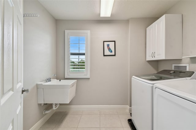 13311 Dorado Shores Ave, Riverview, FL 33579 - laundry area featuring cabinet space, baseboards, washer and clothes dryer, and light tile patterned floors